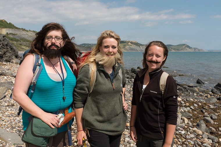 Three of the presenters in the Bearded Lady project pose on the foreshore at Lyme Regis - note Golden Cap in the background. (Credit: Kelsey Vance)